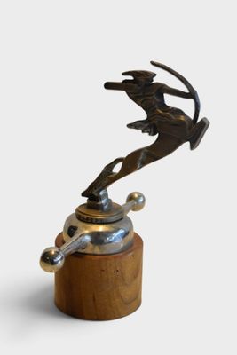 statue of a man riding a horse on top of a wooden base