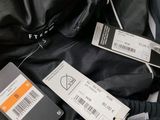 two tags on the back of a jacket and a pair of pants