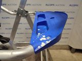 a close up of a blue plastic object on the handlebar of a bike