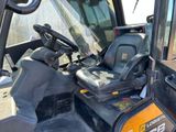 a close up of the driver ' s seat of a construction vehicle
