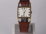 a small square watch with roman numerals on the face