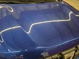 a picture of a blue sports car parked in a garage