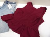 two pieces of clothing are laying on a table with a price tag