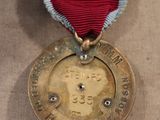 medals are displayed on a table in a museum setting