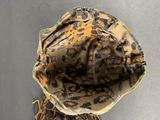 a camouflage hat with a tassel hanging from it