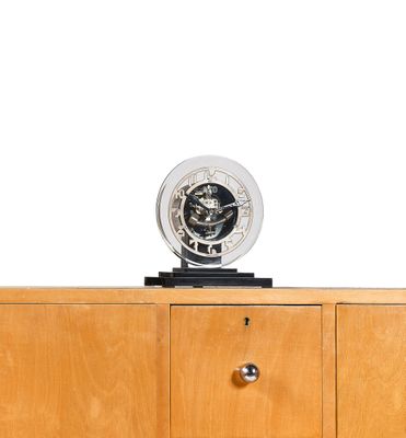 a clock that is on top of a wooden cabinet