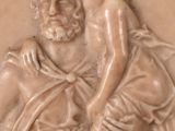 a statue of a man holding a child in his arms