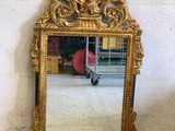a mirror that is sitting on the floor in front of a wall