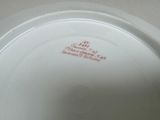 a white plate with red writing on it sitting on a table