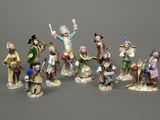 many figurines of people that are standing together