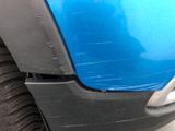 a close up of a car ' s front bumper and fender