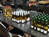 many bottles of wine sitting on a table in a room