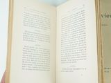 an open book with a hand holding a book open to a page