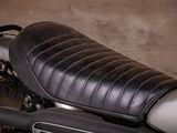 a close up of a motorcycle with a leather seat