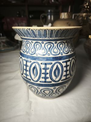 a blue and white vase sitting on a table