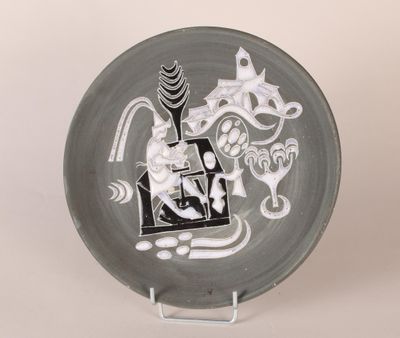 a black and white plate with a picture of a cat on it