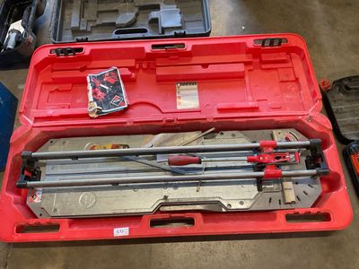 a red tool box with tools in it on the floor