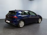 the back end of a blue car parked in a garage