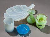 several pieces of glass sitting on top of a table next to each other