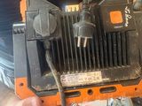 a man that is holding a tool in his hand