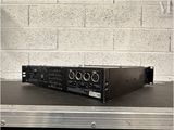 an image of a black amplifier sitting on top of a metal table