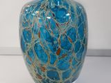 a glass vase with a blue and gold design on it