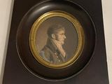painting of a man in a suit and tie in a black and gold frame