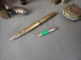 a pen and a pencil sitting on a table