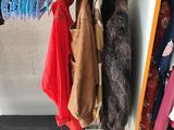 an image of a closet with a suitcase and clothes