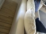 a picture of a living room with a white couch and a coffee table