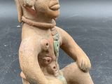 an image of a statue of a man with a baby in his lap