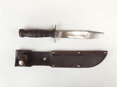 a knife and a knife holder on a white surface