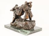 statue of a man and a woman on a rock with a dog