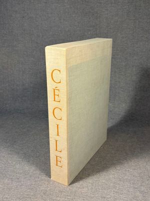 a close up of a book on a table with a gray background