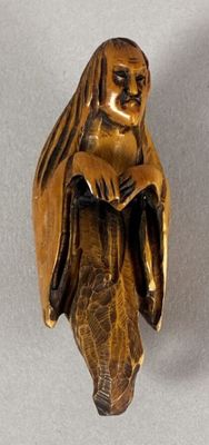 a statue of a woman holding a cat on her lap