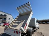 a white dump truck parked in a parking lot