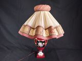 a lamp that is sitting on a table with a black background