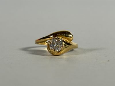 a close up of a gold ring with a diamond on it