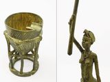 two pictures of a statue of a woman holding a stick and a bowl