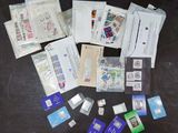 many different types of stamps and envelopes on the table