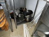 pots and pans are sitting on a shelf in a kitchen