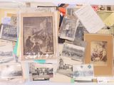 a lot of old photographs and postcards on the table