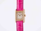 a very pretty pink watch with a diamond bezeled face