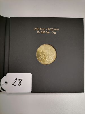 the gold coin is in a black box with a tag on it