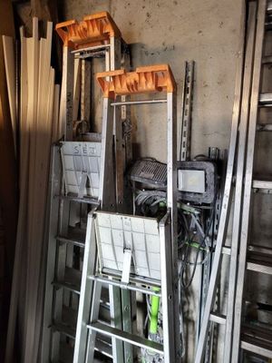 several ladders are stacked on top of each other in a room
