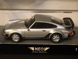 a silver toy car in a display case on a table