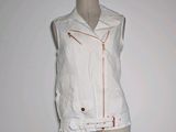 a mannequin wearing a white jacket and shorts on a mannequin stand