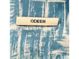 a close up of a label on a blue and white shirt