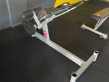 a gym room with a bench and weights on the floor