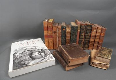 several old books are stacked on top of each other on a table